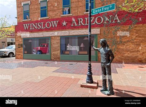 Glen Frey Bronze Statue Stands By Streetlight Pole Labeled With Street