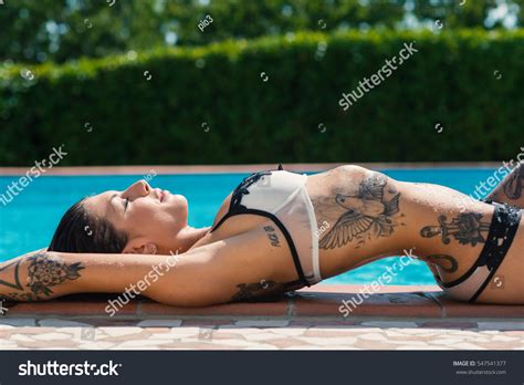 Sexy Tattooed Woman Portrait Bikini Sunbathing Stock Photo