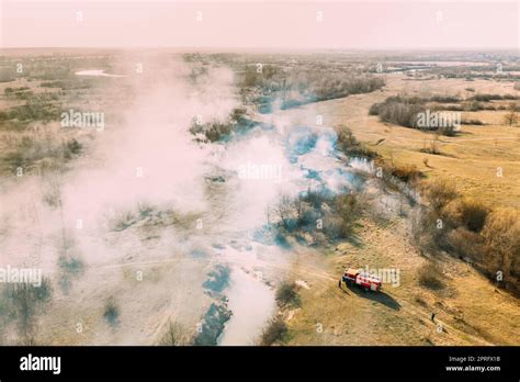 Aerial View Spring Dry Grass Burns During Drought Hot Weather Bush Fire And Smoke Fire Engine