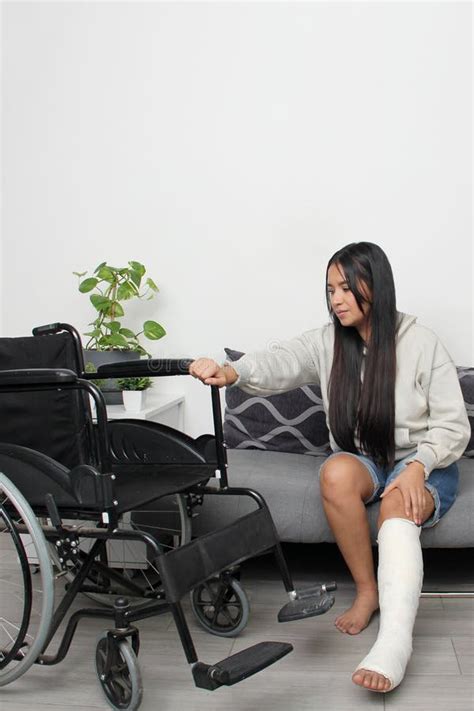 30 Year Old Latina Woman With Her Leg In A Cast That Accidentally Broke Uses A Wheelchair For