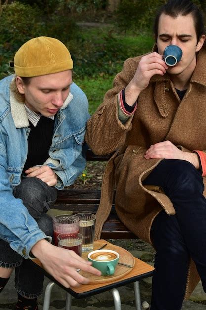 Premium Photo Two White Males One Blonde Another Brown Haired Drinking Coffee And Raspberry