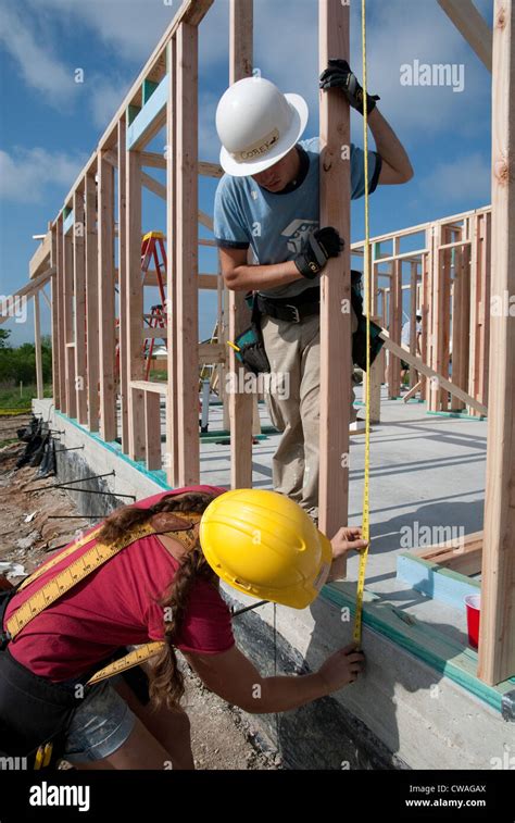 company employees volunteer  time  build  affordable house