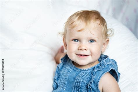 Newborn Baby Girl With Blonde Hair And Blue Eyes