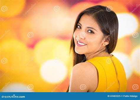 Attractive Brunette Wearing Yellow Dress Posing Naturally And Smiling Beautiful To Camera With