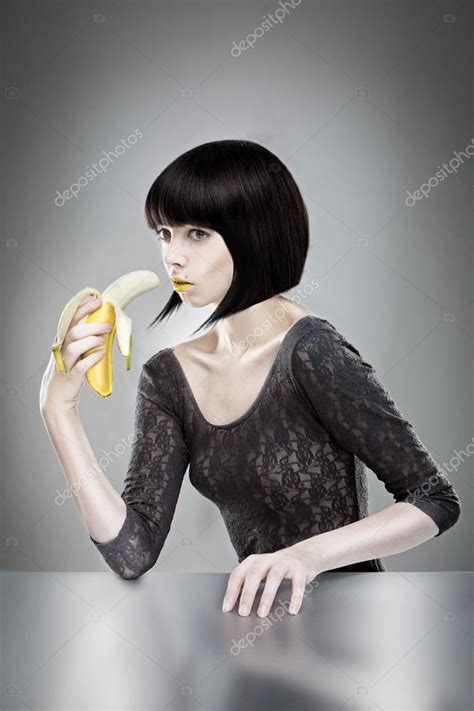 Brunette Holding Banana Stock Photo By Nelka