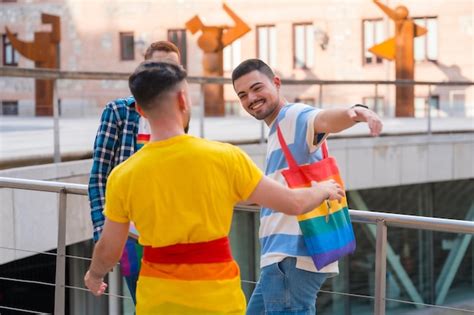 Premium Photo Man Waving And Hugging At The Demonstration With The Rainbow Flags Gay Pride