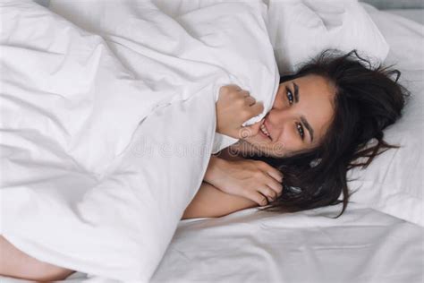 Portrait Of A Nude Brunette Girl Lying In Bed Under A Blanket Stock Photo Image Of Natural