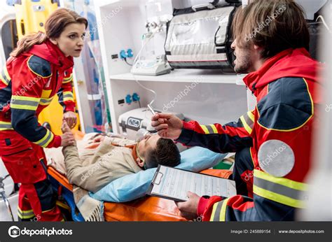 Paramedics Helping Unconscious Man Ambulance Car Stock Photo