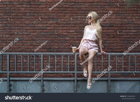 Beautiful Blonde Girl Sitting On Railing Stock Photo Shutterstock