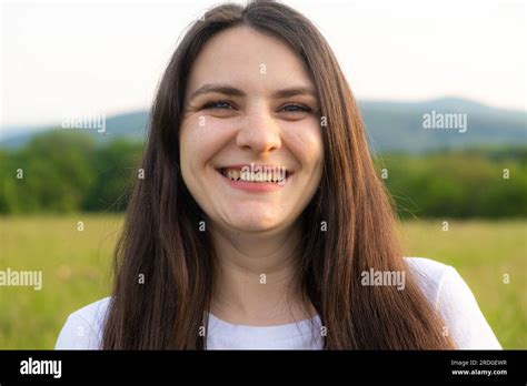 Portrait Of A Year Old Brunette Woman Looking At The Camera Smiling In Nature Stock Photo Alamy