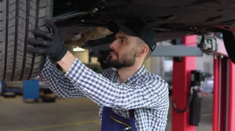 Auto Mechanic Working Under Car On Hydra Stock Video Pond5