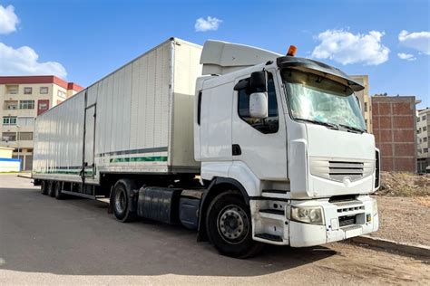Premium Photo A Long White Trailer Truck Parked On The Road