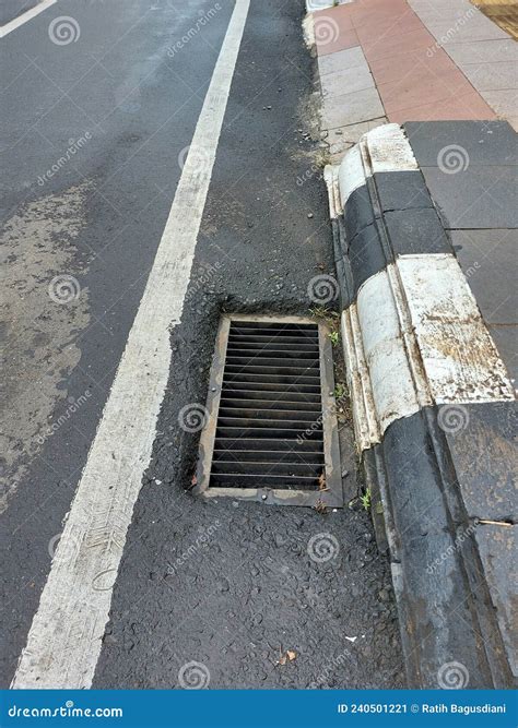 Drainage Holes. by the Asphalt Road Stock Image - Image of facilities