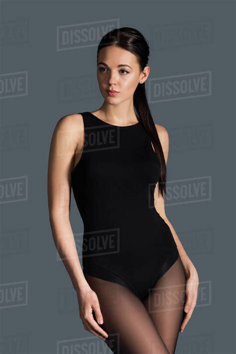 Brunette Girl Wearing Black Bodysuit Isolated On Dark Background Royalty Free Stock Photo