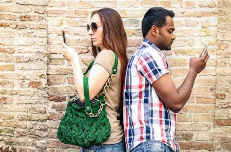 Premium Photo Bored Multiracial Couple Using Mobile Smart Phone