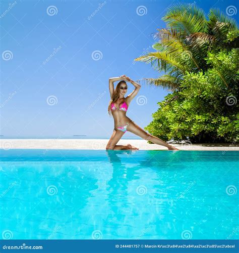 Woman In Bikini Near The Pool At Maldives Tropical Island Elegant