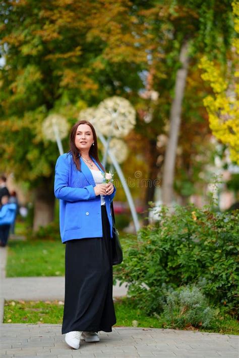 Attractive Brunette Woman In Blue Jacket With Rose Flower Stock Photo Image Of Holiday