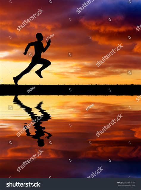 Silhouette Of Running Man On Sunset Fiery Background Silhouette Of Man