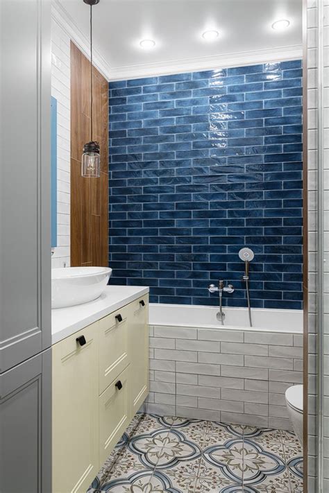 a bathroom with blue and white tiles on the walls