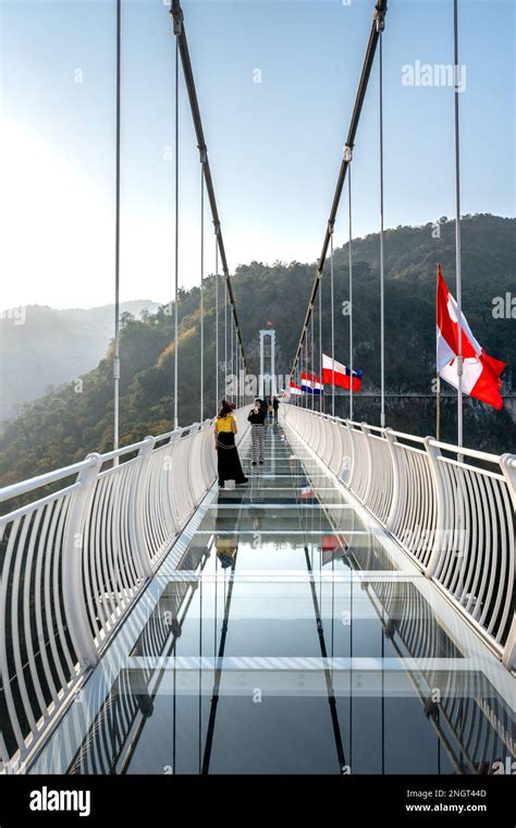 A Female Tourist Enjoys Walking On Bach Long Glass Bridge This Is The