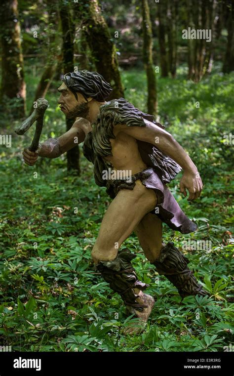 Neanderthal Hunter Chasing Prey In Forest At Prehisto Parc Theme Stock