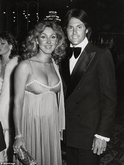 A Man In A Tuxedo Standing Next To A Woman In A Dress At An Event