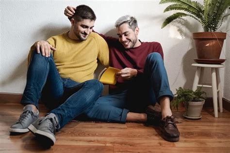 Premium Photo Gay Male Couple Reading Book Together Indoor At Home Lgbt Homosexual Love