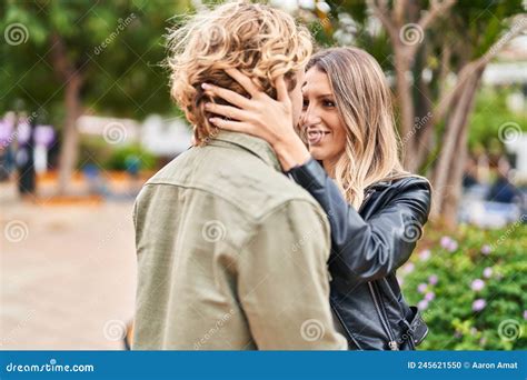 Man And Woman Couple Smiling Confident Hugging Each Other At Park Stock