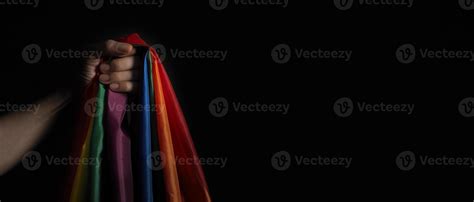 Lgbtq Pride Flag On Black Background Lgbt Rainbow Flag In Gay Hand Stock Photo At