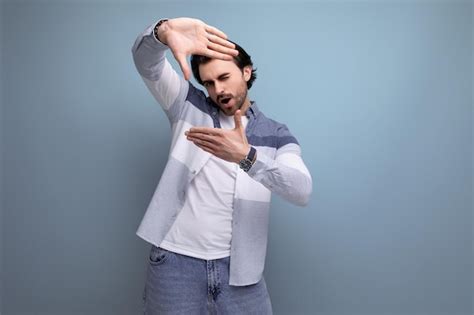 Premium Photo Nice Brunette Guy In Casual Style Takes A Photo With His Hands