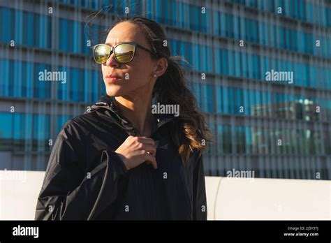 Fit Female Athlete In Black Activewear And Sunglasses Standing Looking