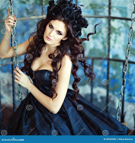 Curly Sensual Brunette With A Wreath Of Black Flowers Sits On Th Stock Image Image Of Female