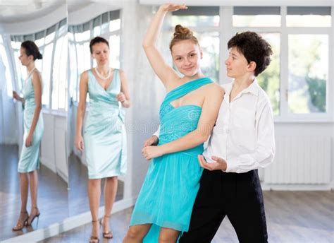 Dance Teacher Teaches A Girl And A Boy Couples Ballroom Dancing Stock