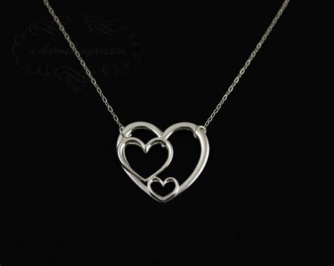 Sterling Silver Triple Heart Necklace By Acharmedimpression