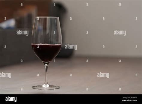 Red Wine In Thin Wine Glass On Wood Table Shallow Focus Stock Photo