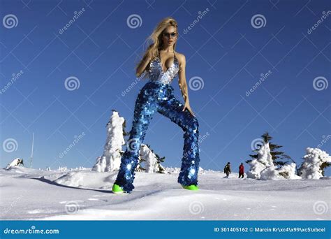Blonde Girl Wearing Winter Glamour Sequin Bikini And Winter Fashionable Boots Is Posing On A