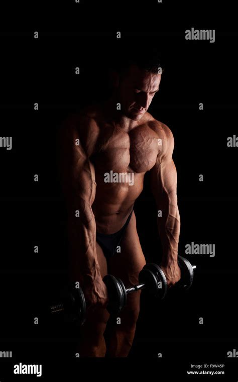 Sexy Shirtless Bodybuilder Holding Dumbbell Isolated On Black