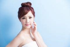 Pretty Girl With Blue Eyes And Blond Hair With Naked Shoulders Looking At Camera Smiling