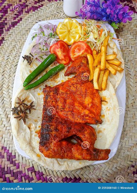 Top View of a Tandoori Chicken on Flatbread with Fries and Vegetables ...