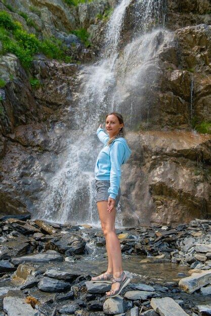 Premium Photo One Girl In Naked Clothes Stands At The Waterfall High Quality Photo