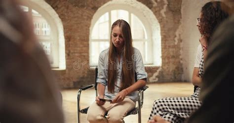 A Blonde Girl With Long Hair Talks About Her Problem While Looking At A Photo And The Rest Of