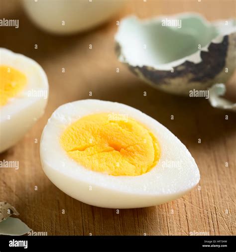 Hard Boiled Quail Egg Half With Egg Shells On Wooden Board