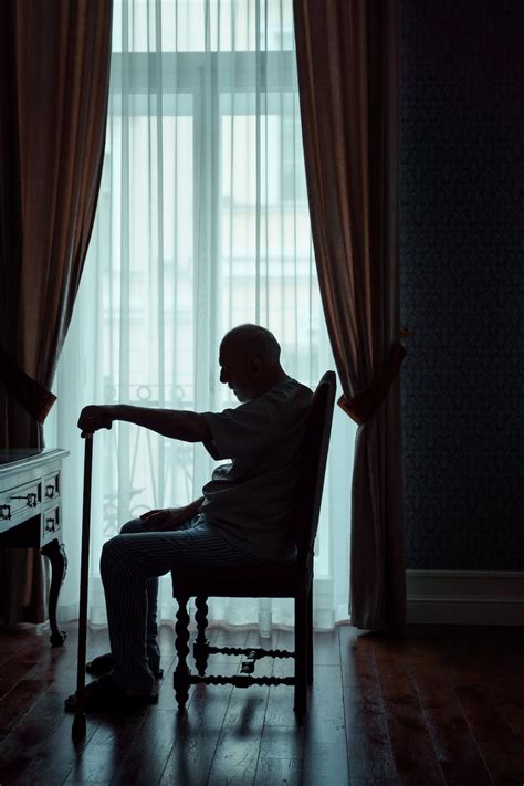 Silhouette Of An Elderly Man Sitting Alone In A Room · Free Stock Photo