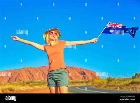 Happy Lifestyle Woman With Australian Flag In Australian Outback Red