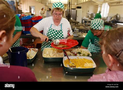 Dinner Ladies Serving School Meals At A School In Exeter Devon Uk Stock