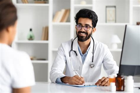 Premium Photo Indian Male Doctor Consulting Woman Patient At Clinic