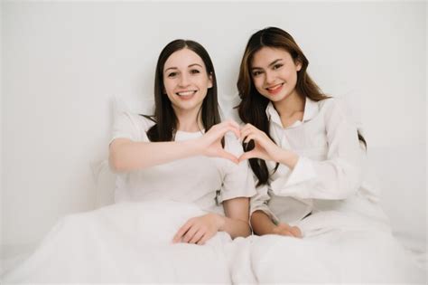 Premium Photo Attractive Lesbian Couple Use Mobile Phone Tablet Watch Movie On Bed Beautiful