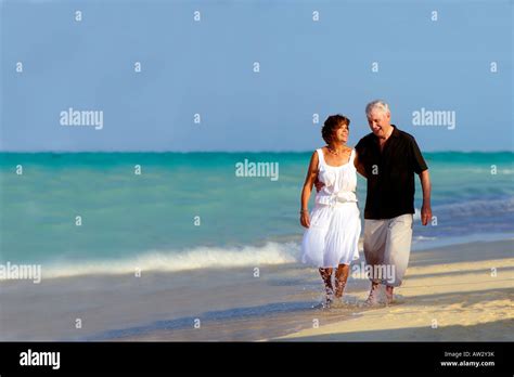 A Senior Couple Walking Along The Beach Stock Photo Alamy