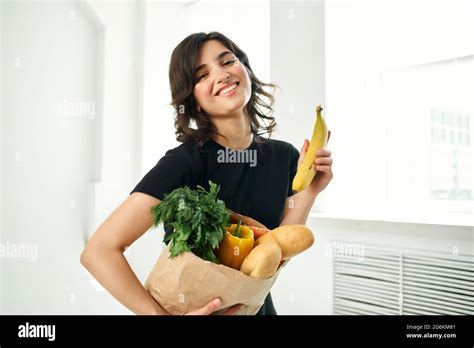 Brunette With A Package Of Groceries Vegetables Healthy Food Stock Photo Alamy