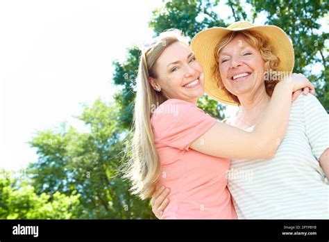 Appreciating The Special Times A Beautiful Mature Woman Hugging Her Senior Mom Affectionately